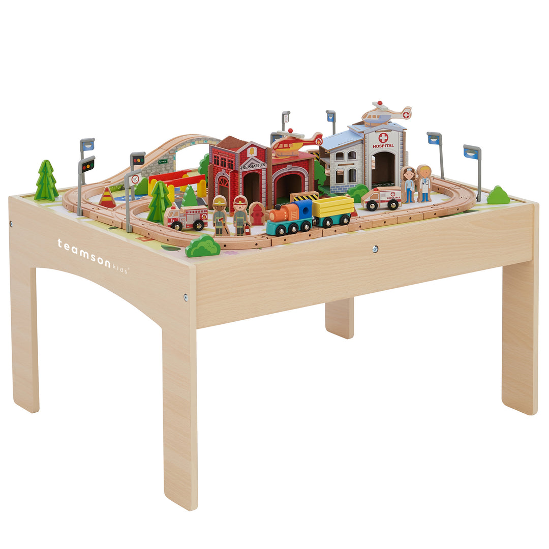 Teamson Kids Preschool Play Lab Toys Wooden Table with 85-pc Train and Town Set, mutli-colored, 4 on a table with track arrangement, buildings, and figures.