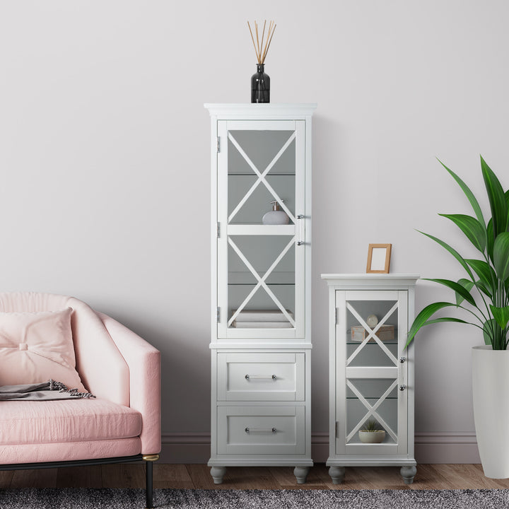 Elegant living room corner with a pink sofa, Teamson Home Blue Ridge Wooden Linen Tower Cabinet with Adjustable Shelves, White, and a decorative plant.