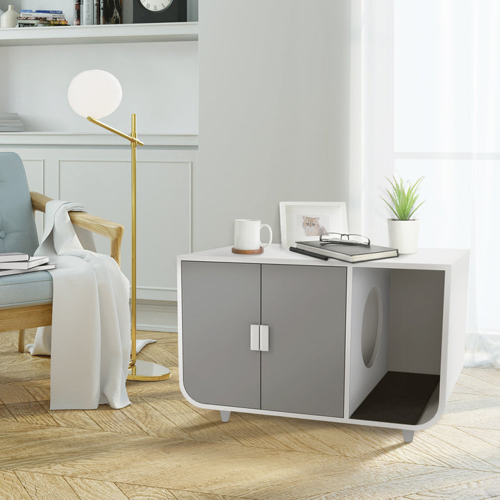 Modern living room with a stylish, durable Teamson Pets Large Dyad Wooden Cat Litter Box Enclosure and Side Table, Alpine White/Gray, armchair, floor lamp, and decorative items.