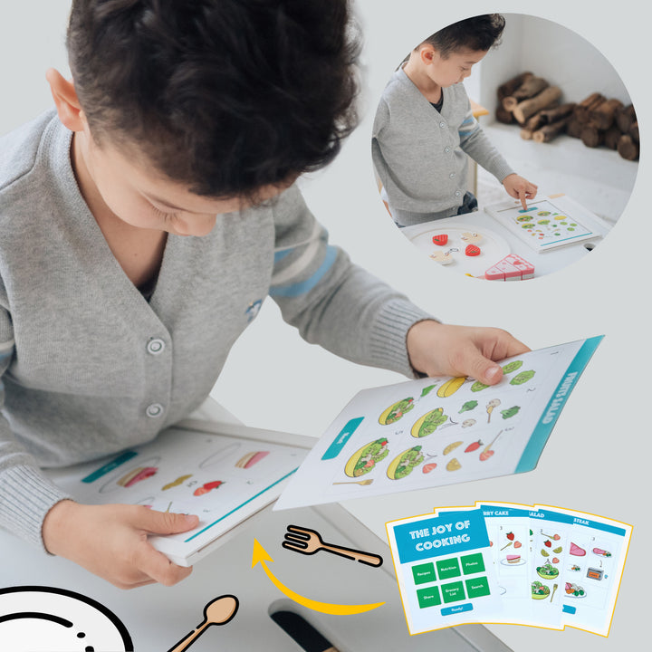 A young child engaging with the Teamson Kids Little Chef Frankfurt 27 Piece Wooden Play Cooking Set with Recipe Tablet and Ingredients, featuring kid-friendly piece design and inset images showing the book's detailed pages.