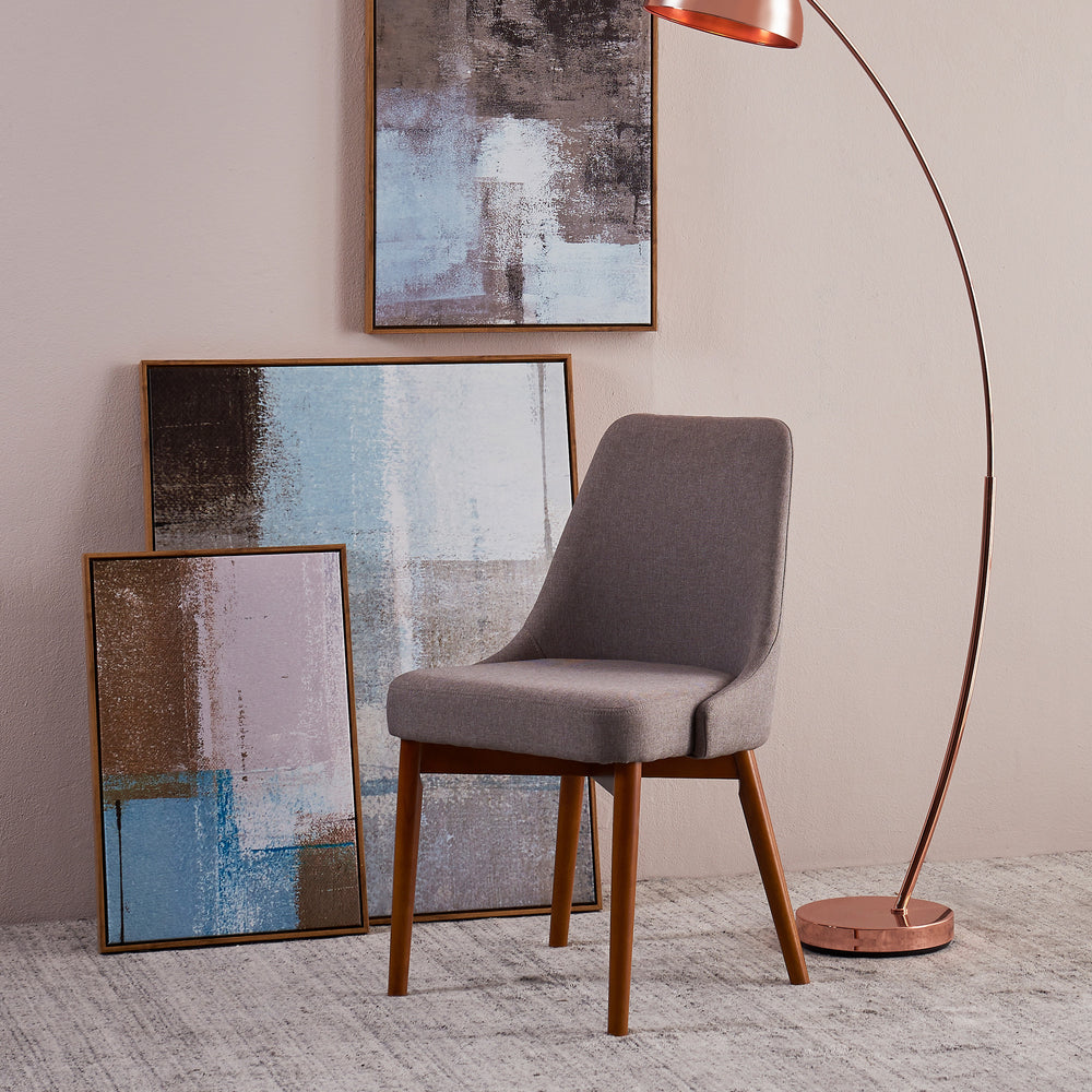 A Teamson Home Grayson Chair with Thick Padding is sitting in front of a painting.
