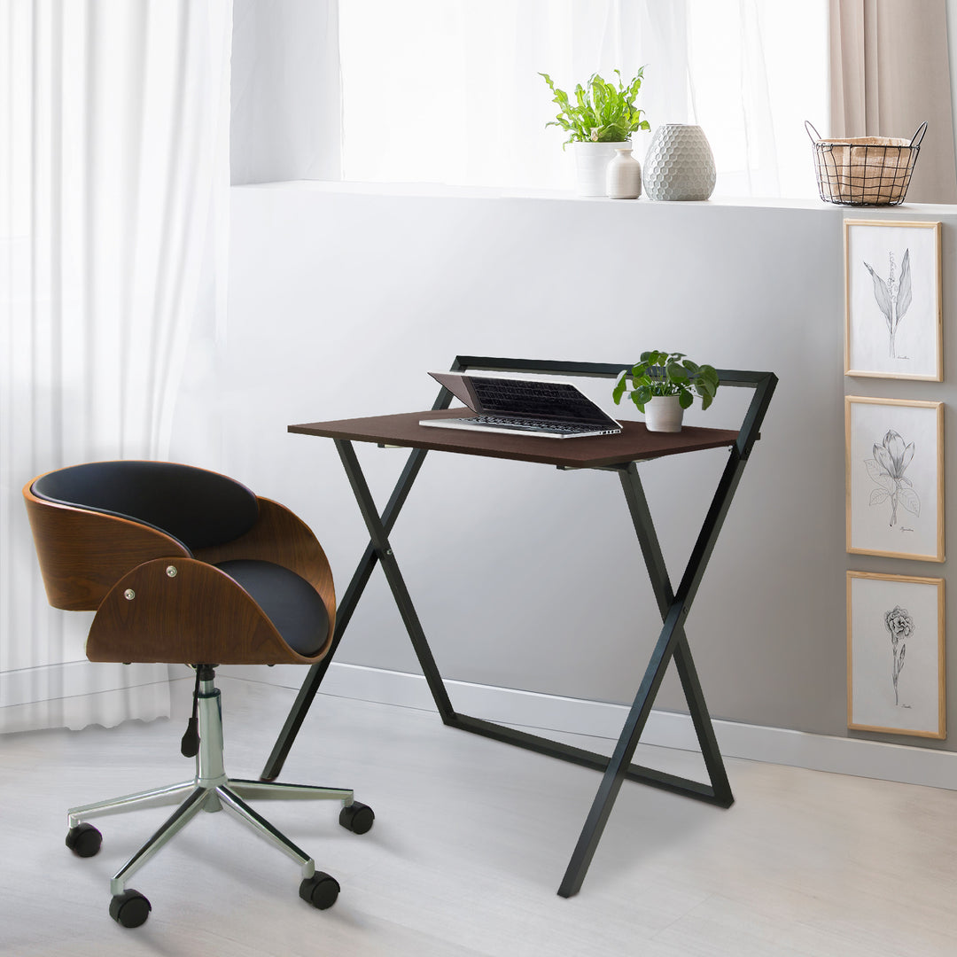 Teamson Home Folding Wooden Computer Desk with Metal Base, Walnut finish/Black by a chair in a room with a window.