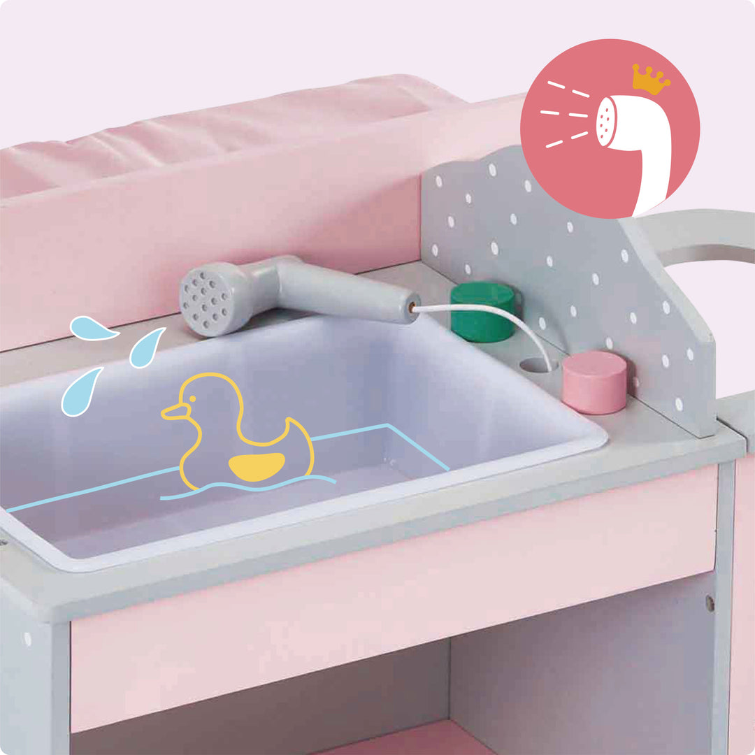 A baby doll changing station in pink and gray with white polka dots with a sink.