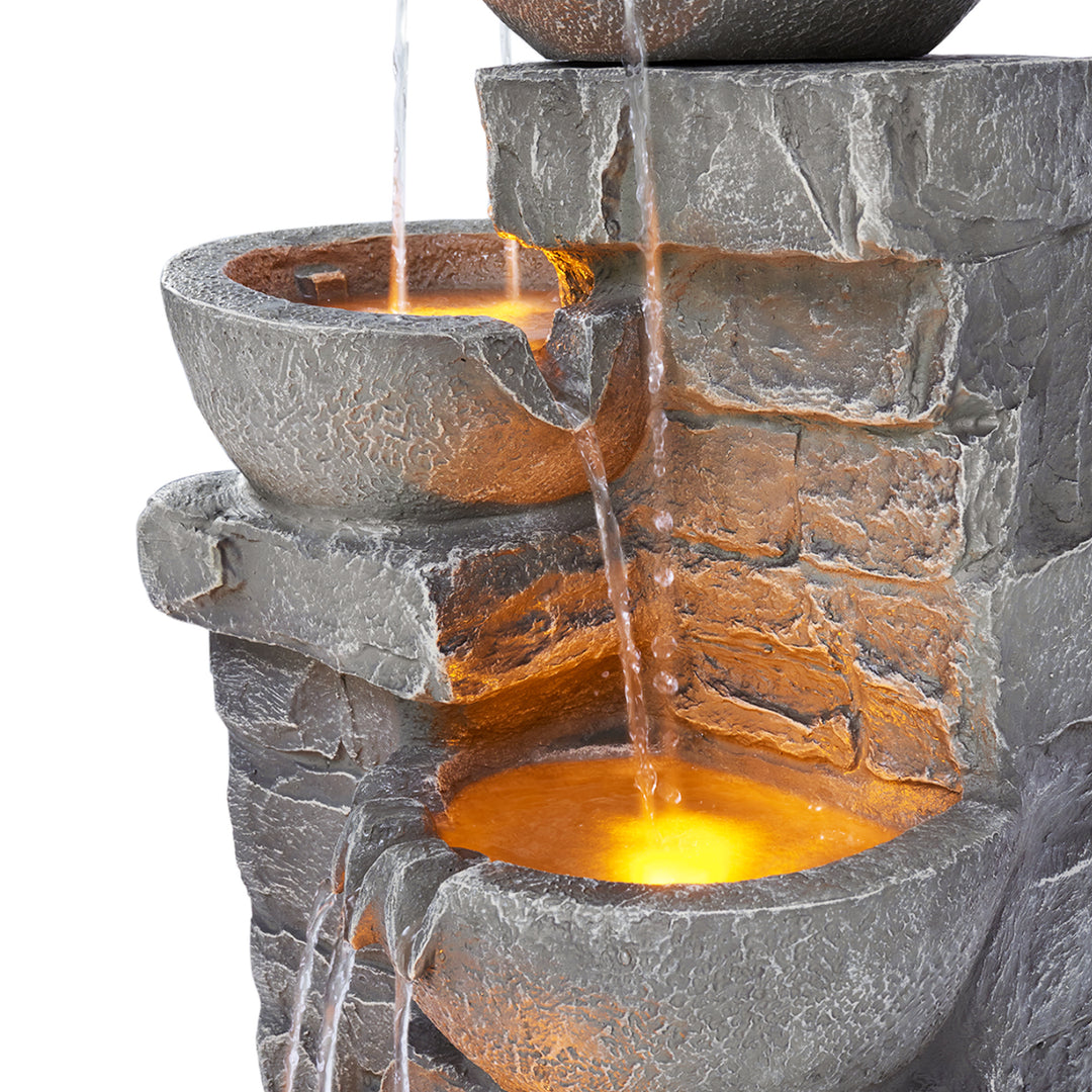 A close-up of the detailed surface of the Teamson Home Outdoor Cascading Bowls & Stacked Stone  water fountain, gray