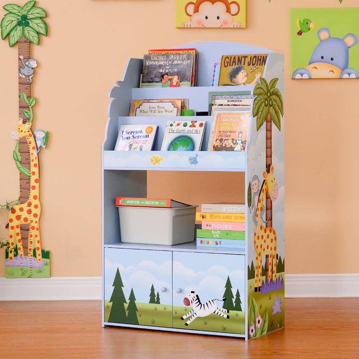 A Fantasy Fields Sunny Safari Kids 3-Tier Wooden Bookshelf with Storage, Multicolor with giraffes and other jungle creatures on it.
