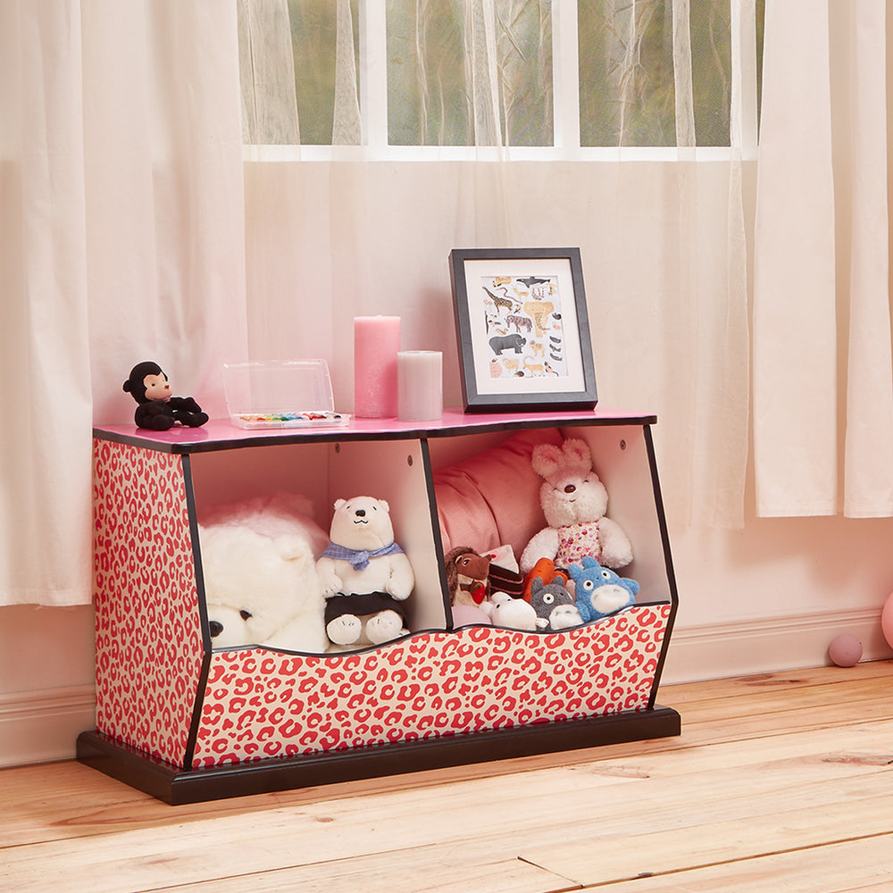 A pink and black two-cubbies storage bench with pink leopard print accents filled with stuffed animals in a playroom.
