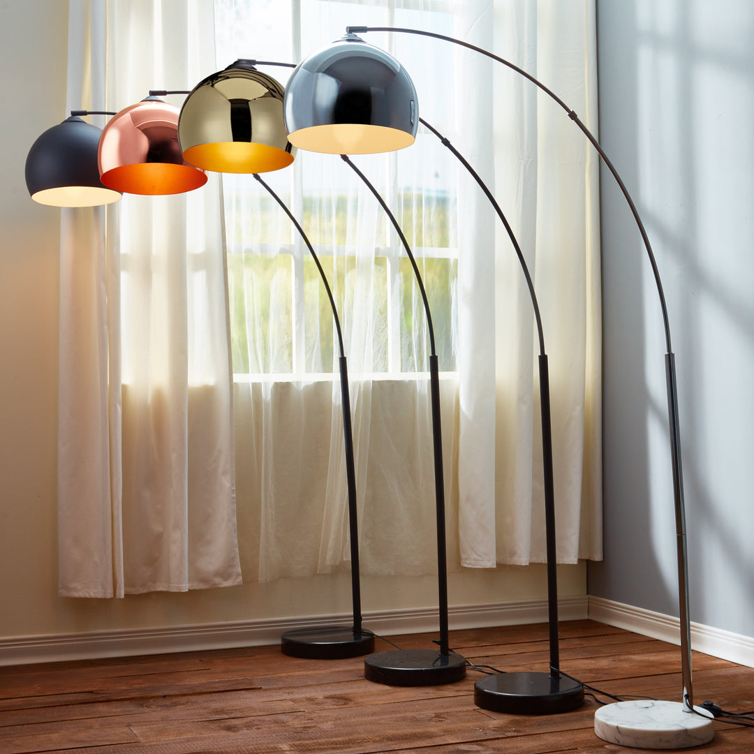 Four Teamson Home Arquer Arc Metal Floor Lamps with bell shades in black, rose gold, gold and chrome.