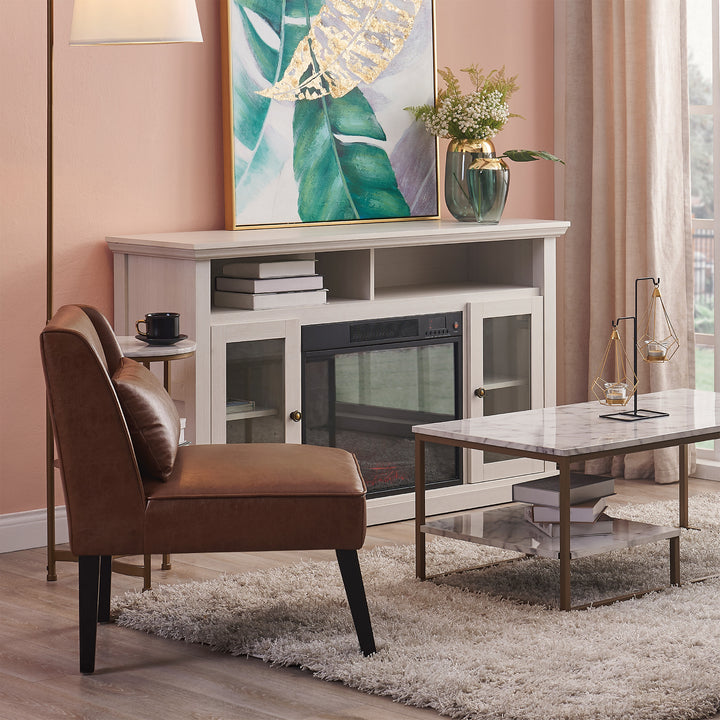 A living room with pink walls, a coffee table, and a Teamson Home Marc Faux Leather Lounge Chair with Pillow and Solid Wood Legs, Brown.
