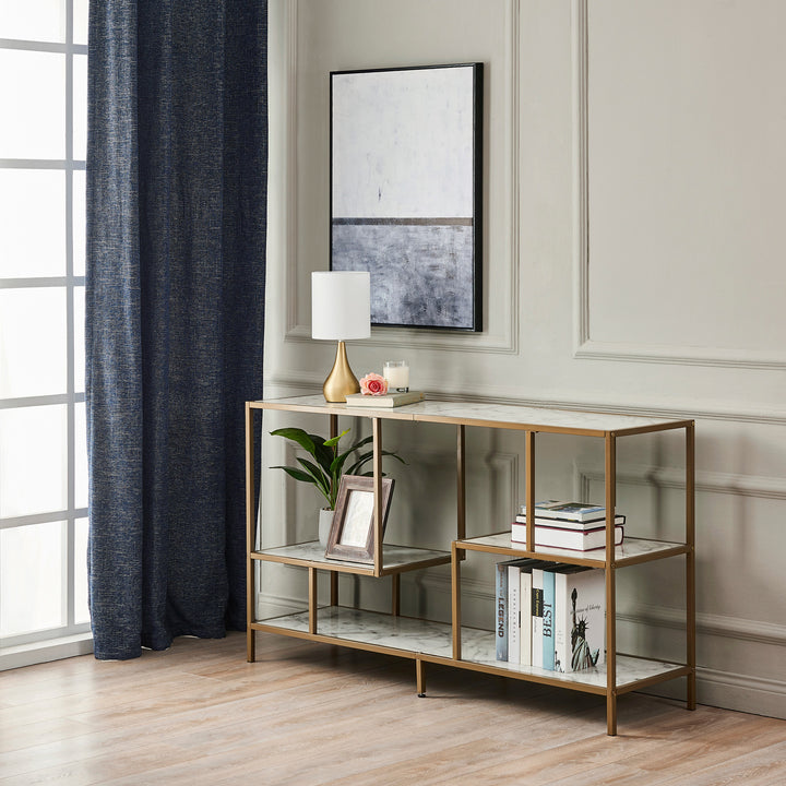 A contemporary living space with Sarah table lamp on a book shelf next to a black shear and a tan wall.