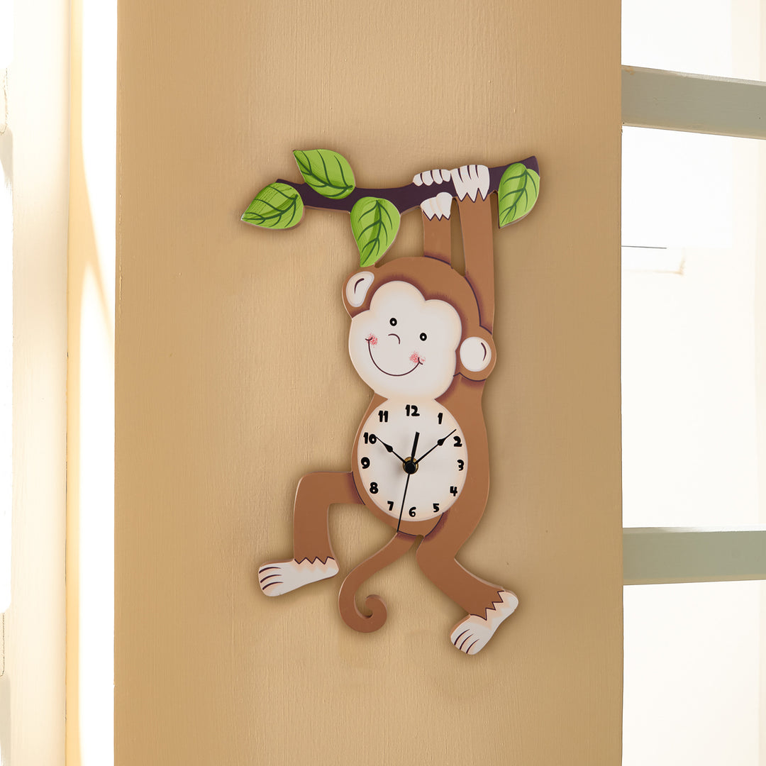 A Fantasy Fields Kids Wooden Sunny Safari Monkey Wall Clock, Brown hanging from a branch.