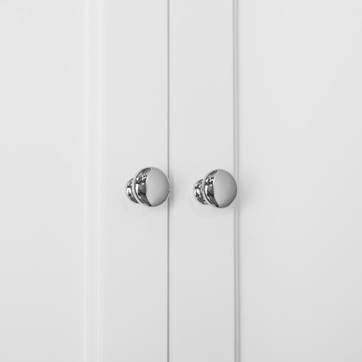 A close-up of chrome knobs on a White Teamson Home Stratford Over-the-Toilet Cabinet with an Open Shelf