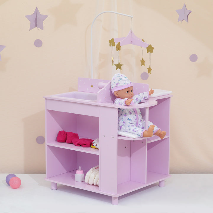 A baby doll changing station in purple with white and gold stars with a baby doll sitting in the high chair.
