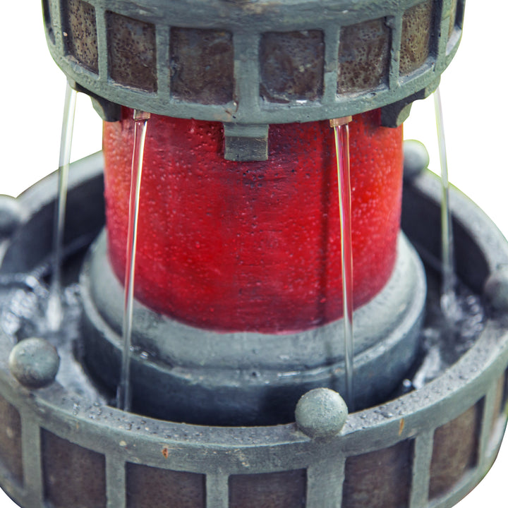 Close-up of the top of the water fountain where the light pours out of the top of the lighthouse into another tier