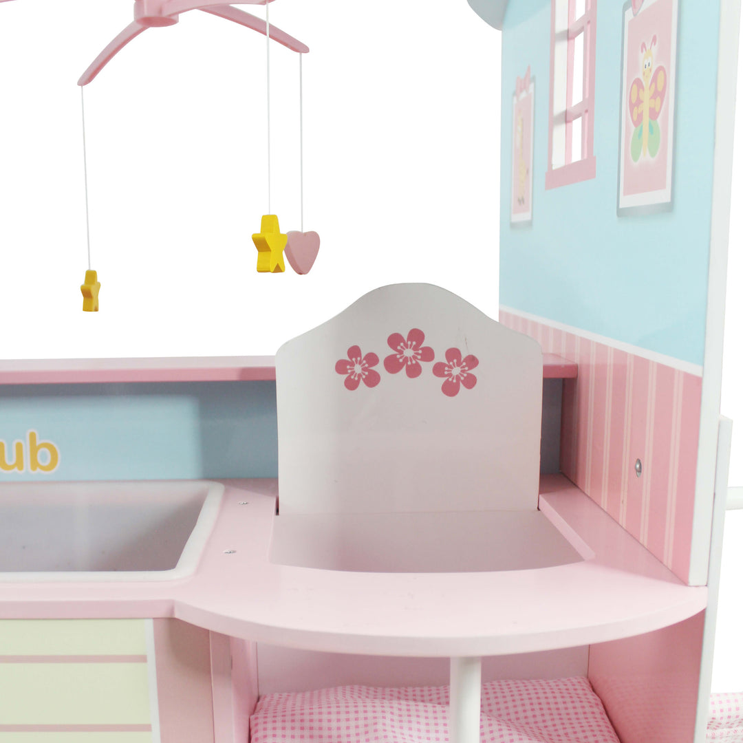 A close-up of the white with pink high chair  floral accents and the pink gingham seat cushion and the mobile with the yellow stars and pink hearts.