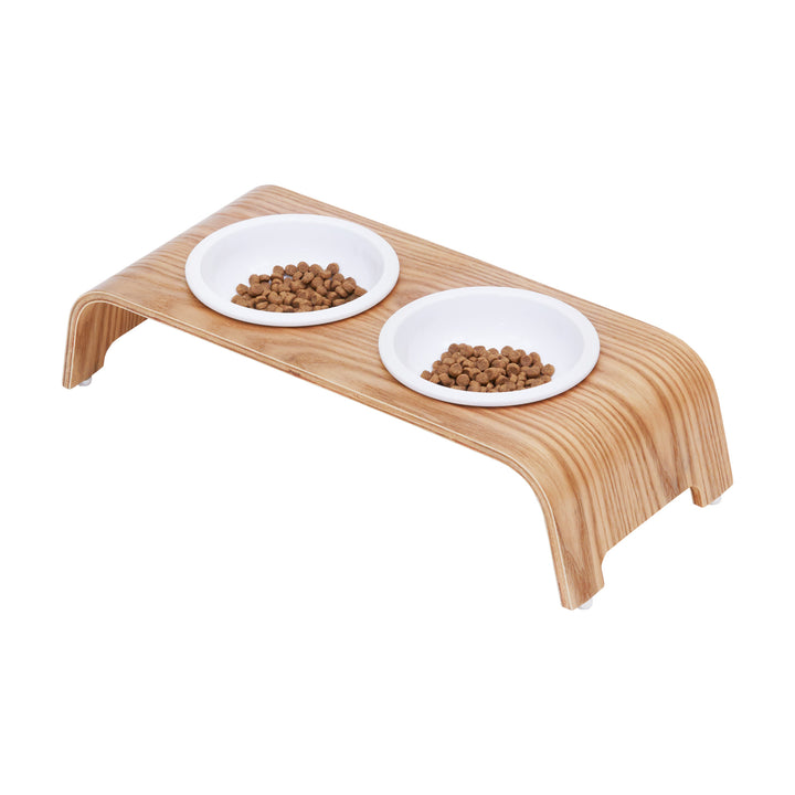 The Billie Small Elevated Ash Wood Pet Feeder with food in the white ceramic bowls 