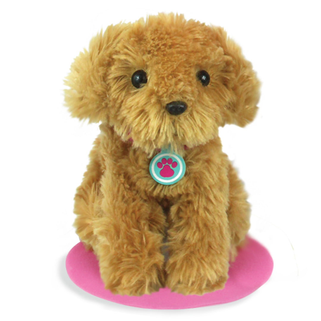 A brown Sophia's Plush Puppy with Carrier and Accessories for 18" Dolls sitting on a pink mat.