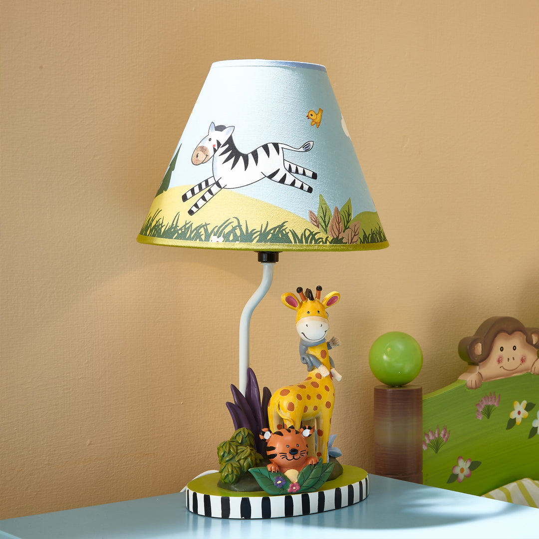 A Fantasy Fields Kids Sunny Safari Table Lamp, Multicolor with a giraffe and zebra on it for a child's bedroom.