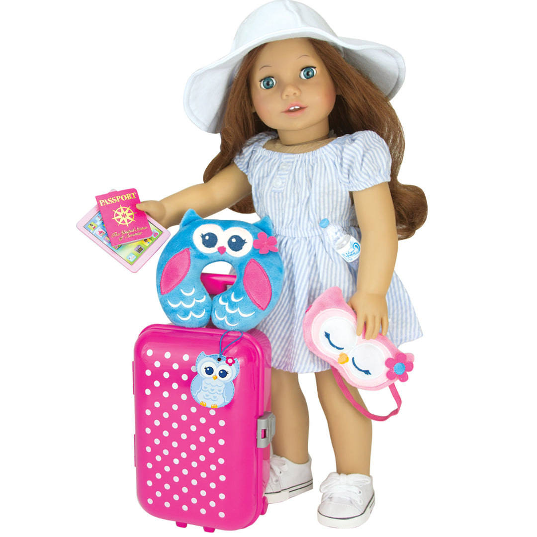 An auburn haired 18" doll holds her passport and tablet in one hand, her owl sleep in the other. With a bottle of water tucked under arm, and an owl travel pillow resting on her pink suitcase, she's ready to go.