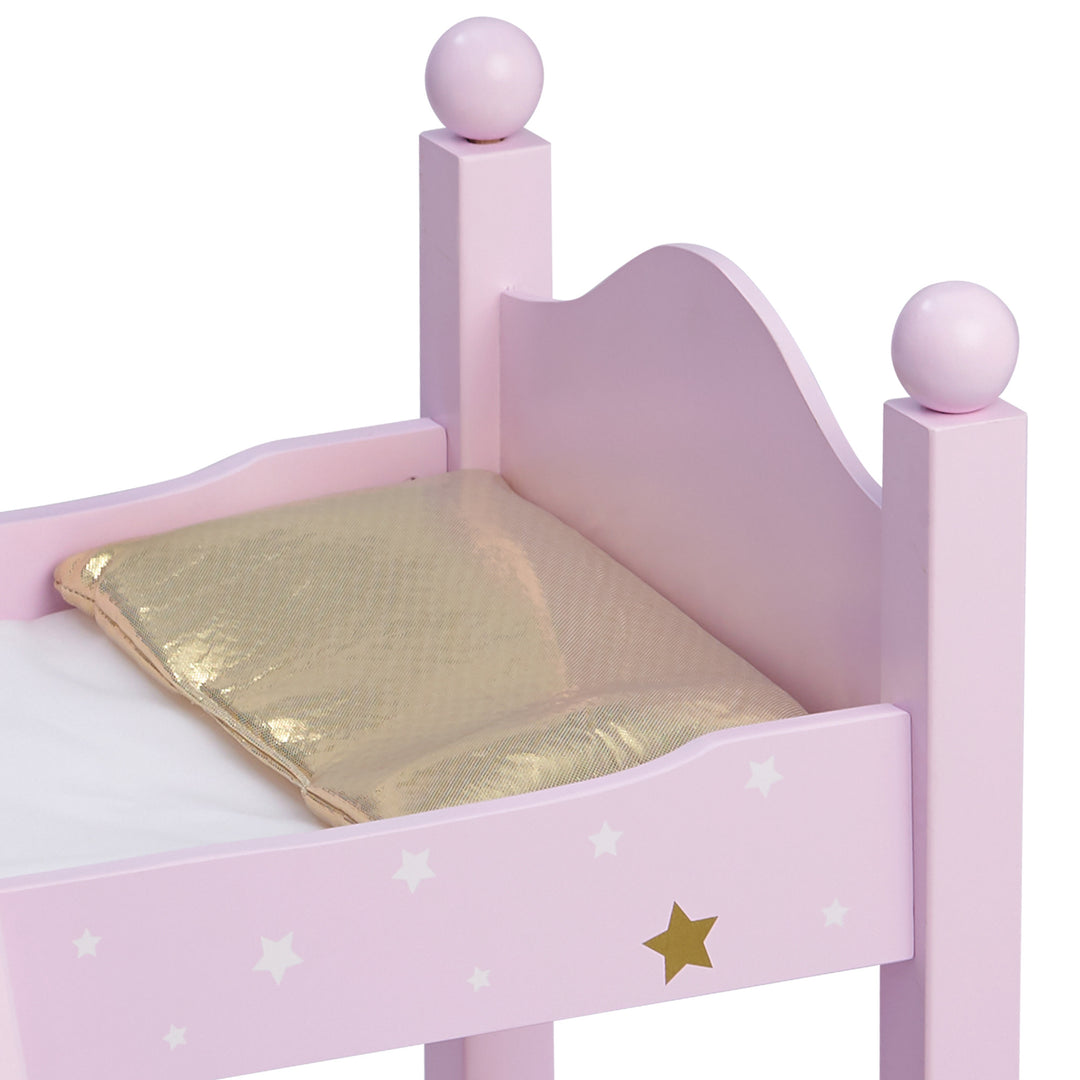 Close-up of a gold pillow on the pink bunk bed.