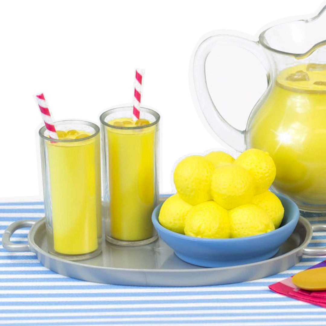 A tray with a bowl of yellow balls and Sophia's Fresh Lemonade Drink Set with Pitcher for 18" Dolls set for kids.