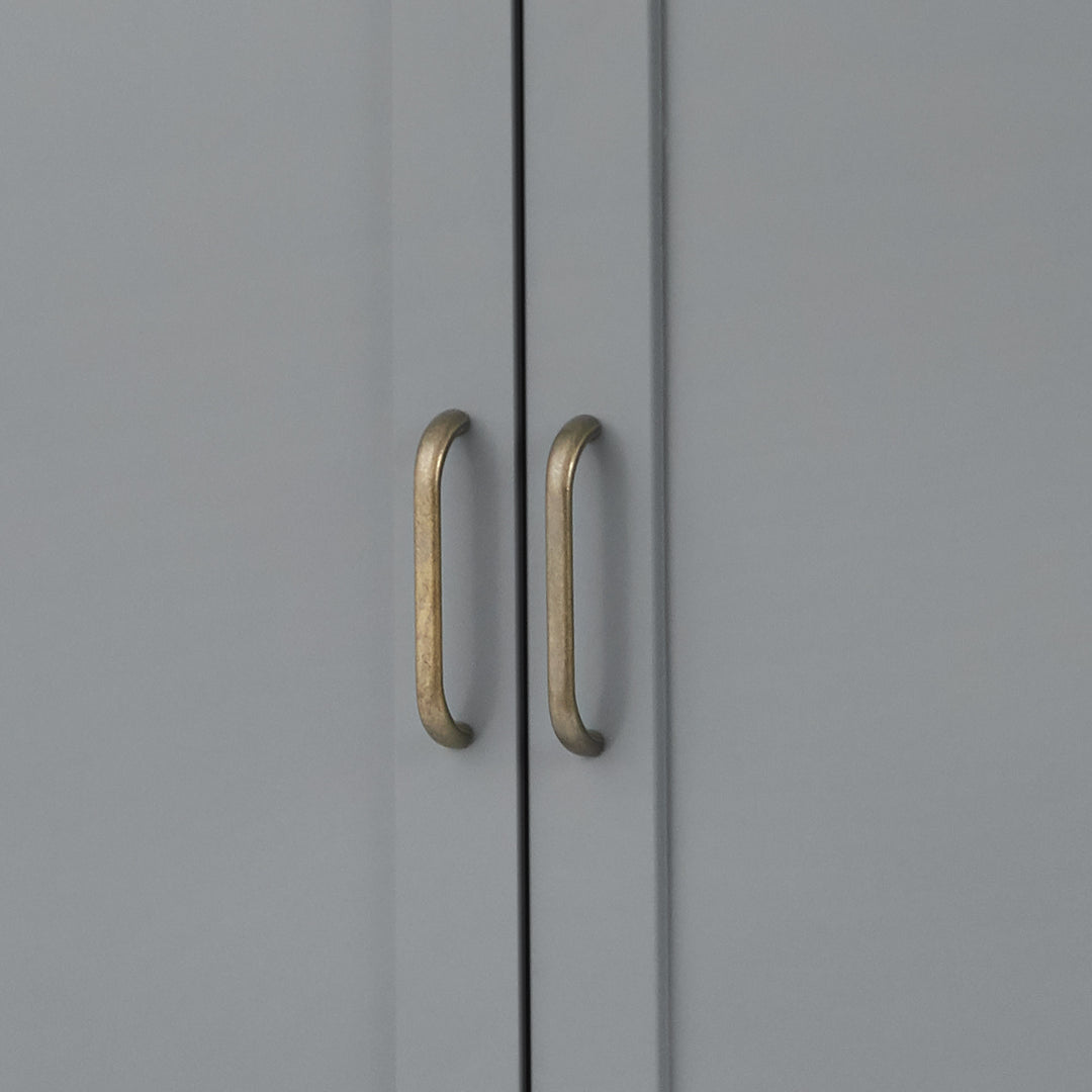 Close-up of the brass pull handles on the cabinet doors on the gray Mercer Storage Cabinet