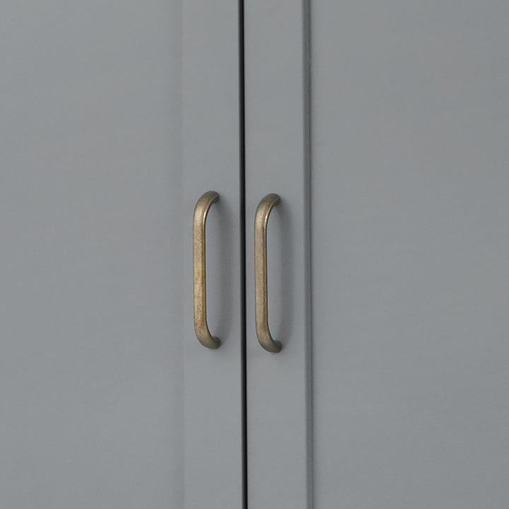 Close-up of the brass pull handles on the cabinet doors on the gray Mercer Storage Cabinet
