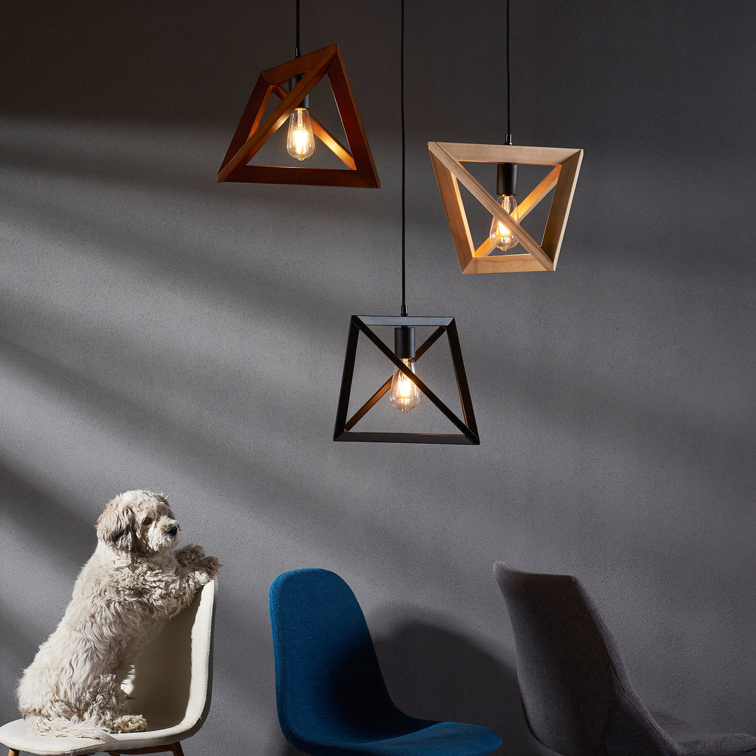 A dog sitting on a chair under a Teamson Home Armonia Geometric Pendant Lamp, Black in a room with modern chairs and a textured wall.