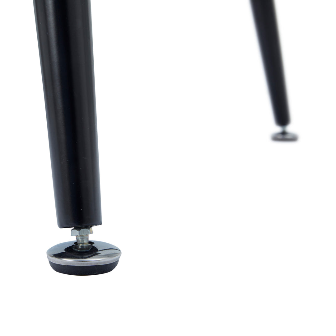 A close-up of the black tapered table legs and furniture sliders