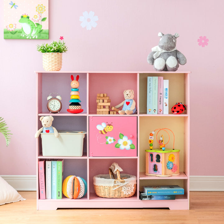 A Fantasy Fields Kids Painted Wooden Magic Garden Adjustable Cube Bookshelf, Pink with toys, a stuffed animal, and durable construction.
