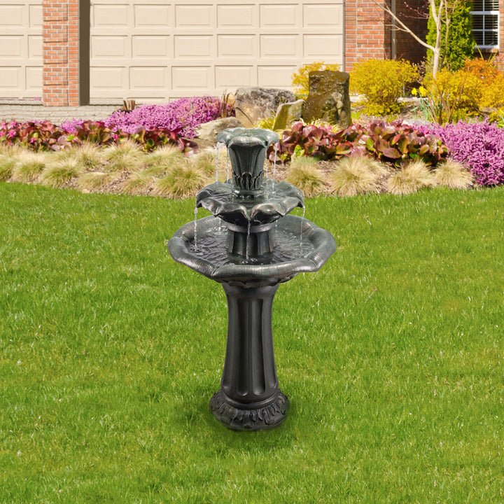 A Teamson Home Outdoor Lily Flower Stone 3-Tier Birdbath Water Fountain, Gray, a durable statue on a well-manicured lawn in front of a residential home