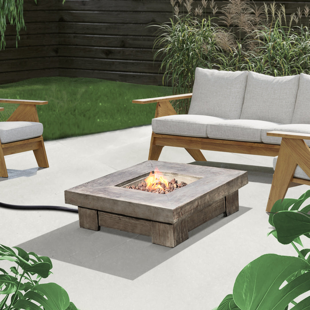 Modern outdoor seating area with a Teamson Home 35" Square Retro Wood Look Gas Fire Pit table.