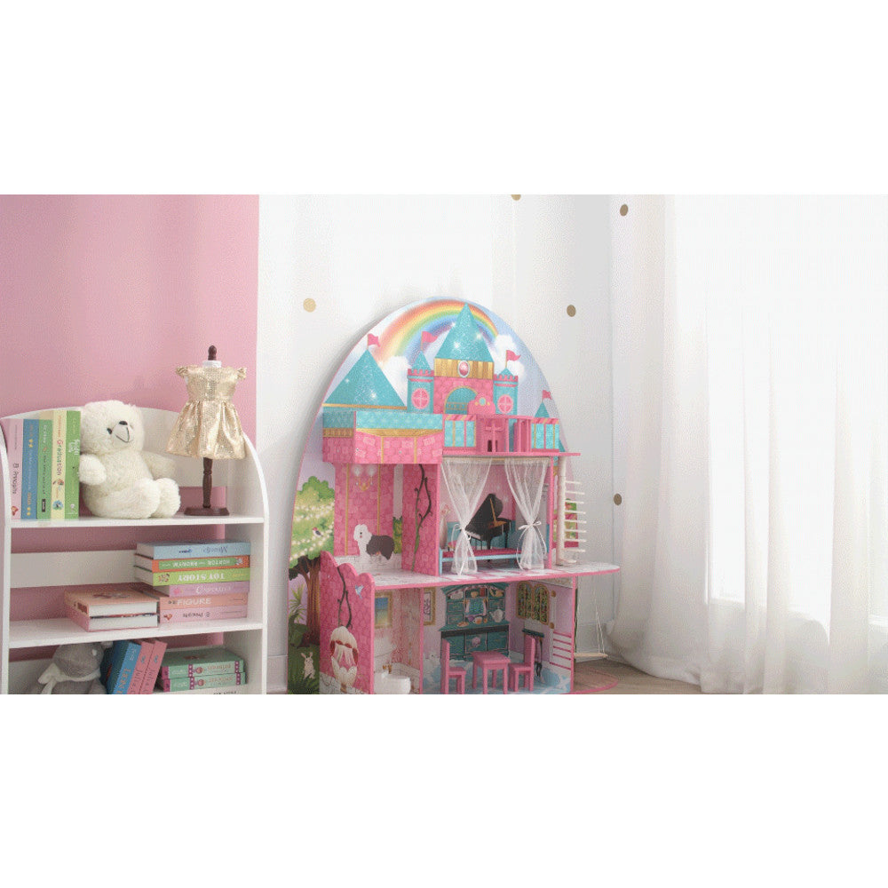 A photo of a child's playroom with the castle dollhouse against a white wall with gold polka dots.