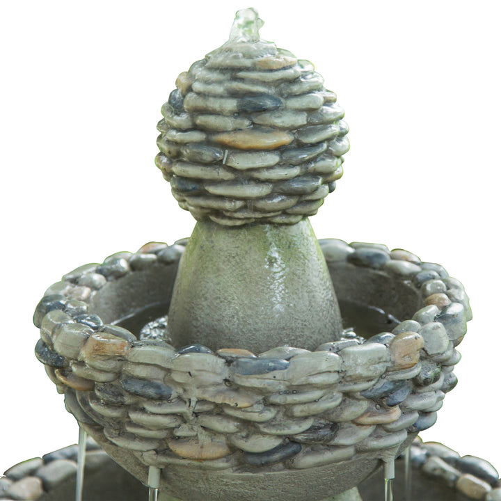 A close-up of where the water bubbles up and down each tier of the faux rock accents on each tier of the water fountain 