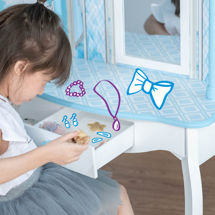 A girl sitting at a table in Fantasy Fields Kids Dreamland Castle Vanity Set with Chair and Accessories, White/Blue with illustrations on what to put in the chest.