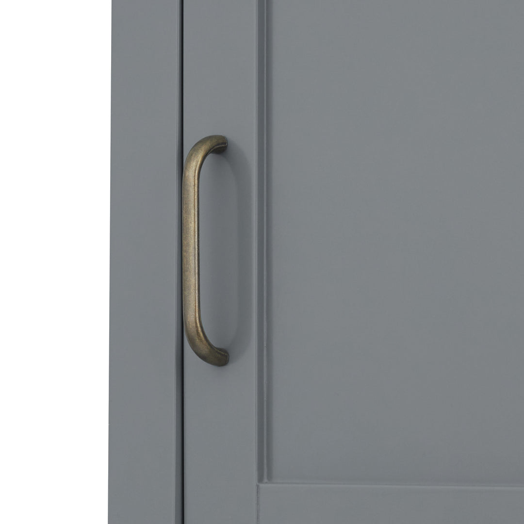 Close-up of the brass pull handle on the Teamson Home Mercer Mid Century Modern Linen Tower Storage Cabinet with Two Doors, Gray