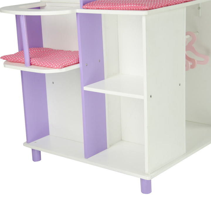 A view of the storage shelves on the baby doll changing station in white and purple with pink cushions.l