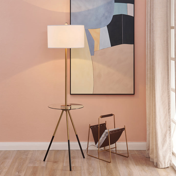 Teamson Home Myra Floor Lamp with Table, Gold/White Shade in a pink room with a painting on the wall.