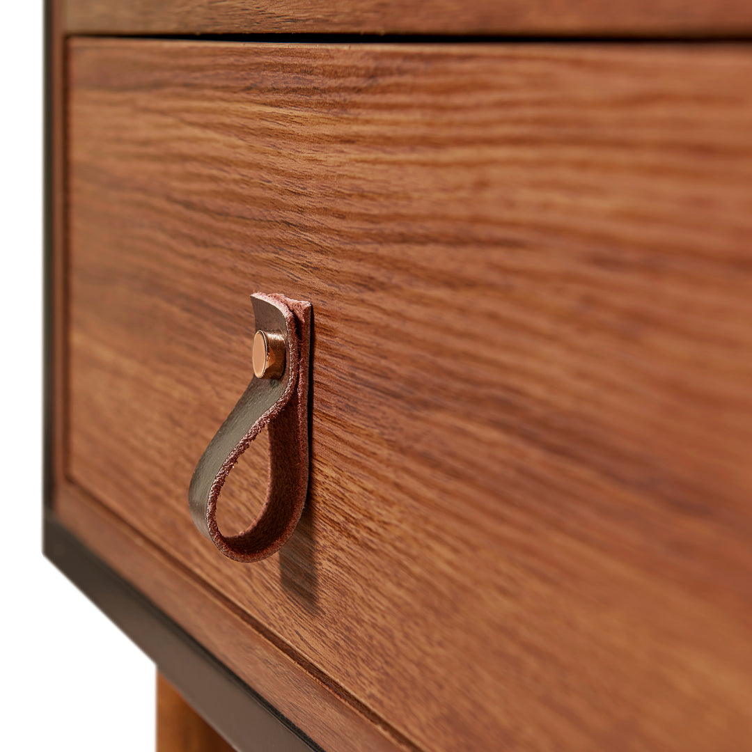 Close-up of the leather loop handle on the storage drawer.