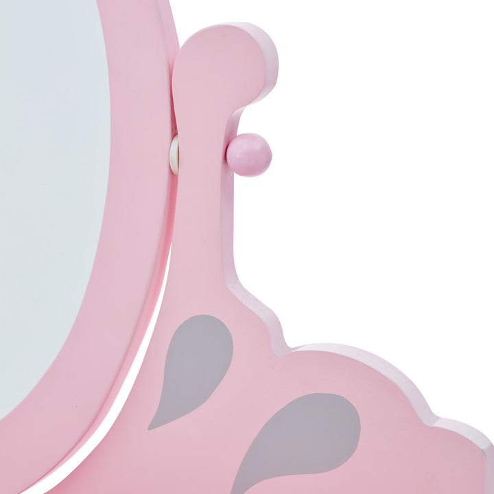 A close up of where the oval mirror tilts on the pink and gray vanity set.