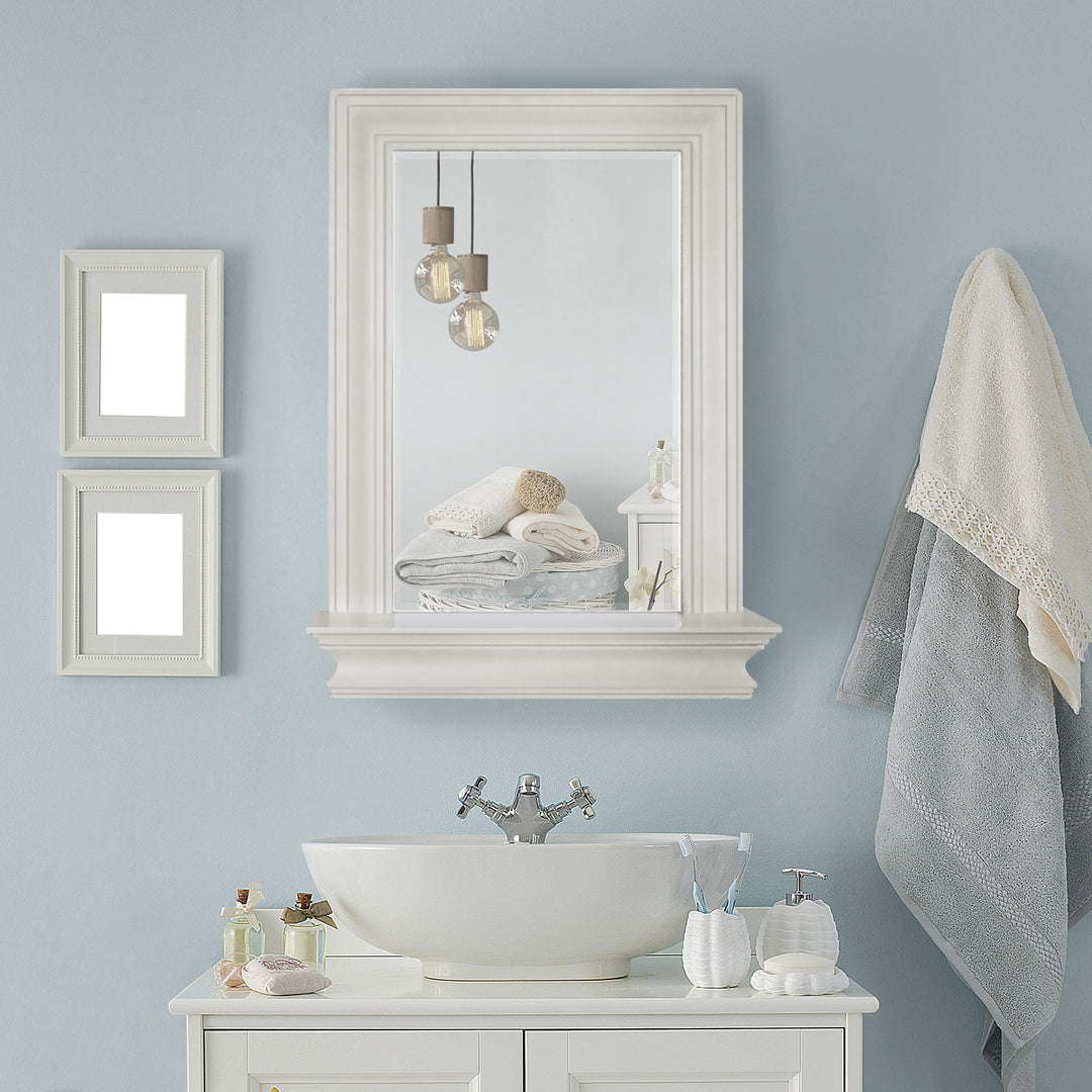 The Stratford Wall Mirror hung above a modern vanity on a light blue wall.