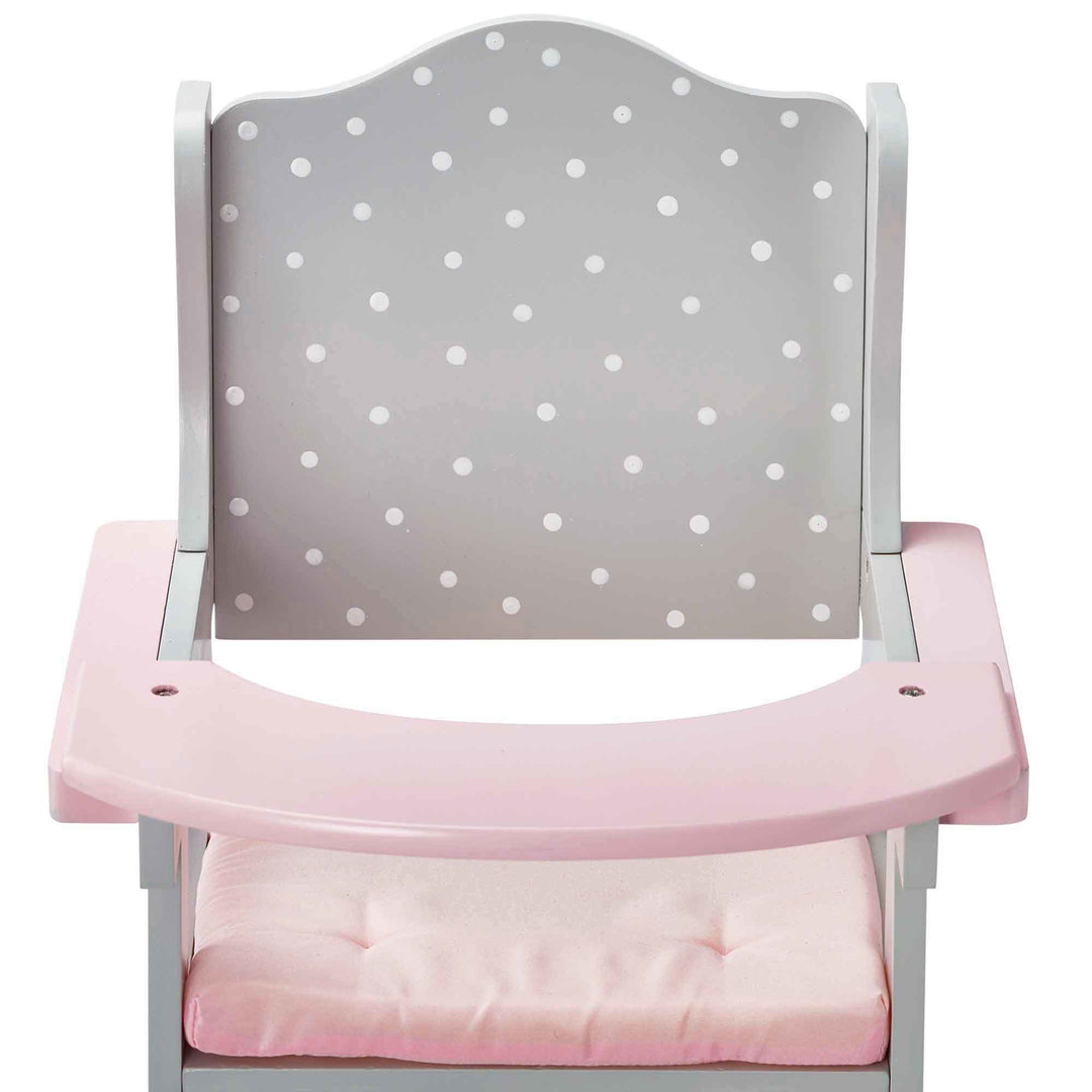 A pink and grey with white polka dots baby doll high chair close-up of the back and tray.