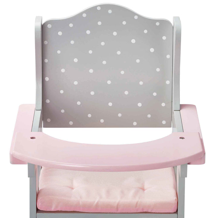 A pink and grey with white polka dots baby doll high chair close-up of the back and tray.