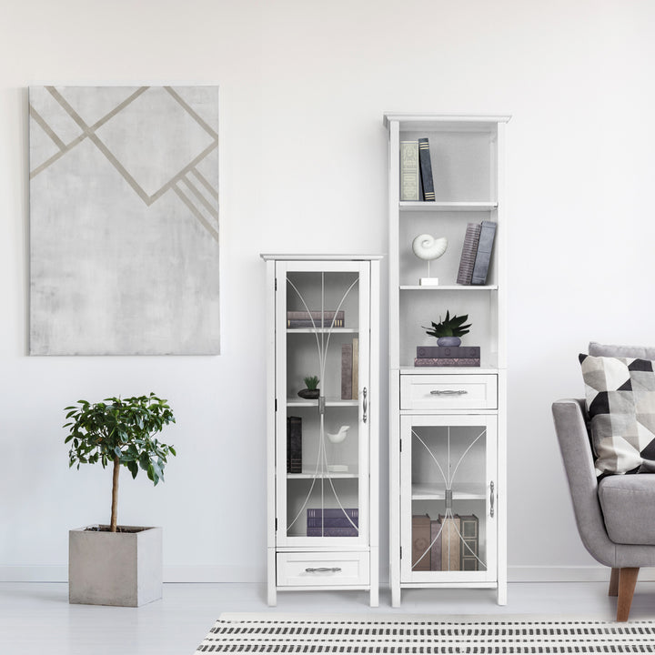 Modern living room with a White Teamson Home Delaney Free Standing Tall Linen Cabinet Tower with Glass Panel Door with a Storage Drawer next to another Delaney cabinet 