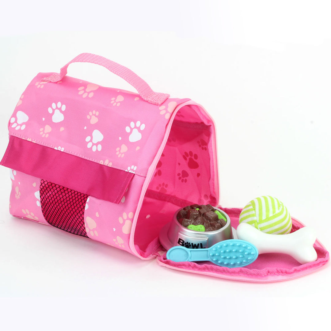 A pink carrier bag with a dog paw prints with a faux food ball, blue brush, white bone and green and white striped ball.