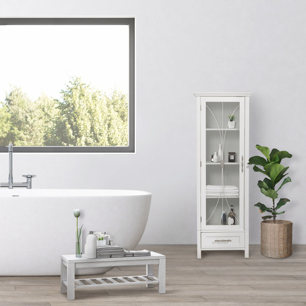 A minimalist bathroom with a freestanding bathtub, a White Teamson Home Delaney Free Standing Tall Linen Cabinet Tower with Glass Panel Door with a Storage Drawer, and a potted plant