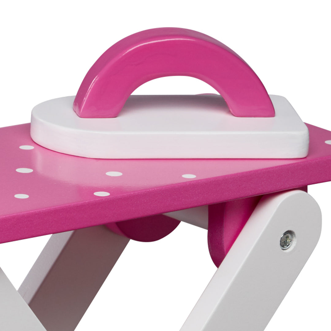 Close-up of a doll-sized iron and ironing board, pink and white.