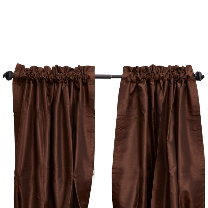 A pair of brown curtains hung on a Sunset Window Curtain Rod Abstract Finial, Black