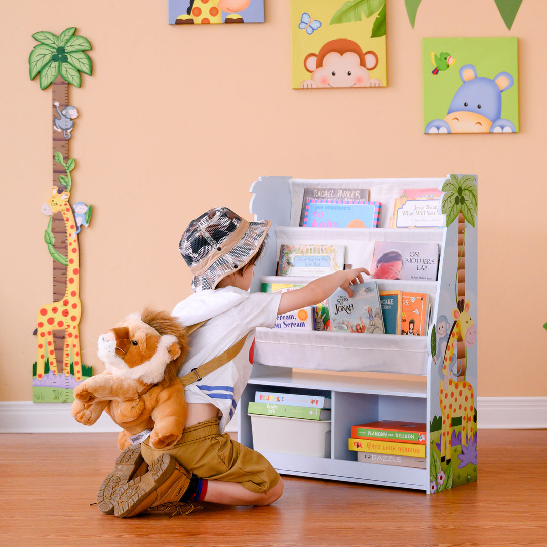 A Fantasy Fields Kids Sunny Safari Wooden Display Bookshelf with Storage, Multicolor on the wall.