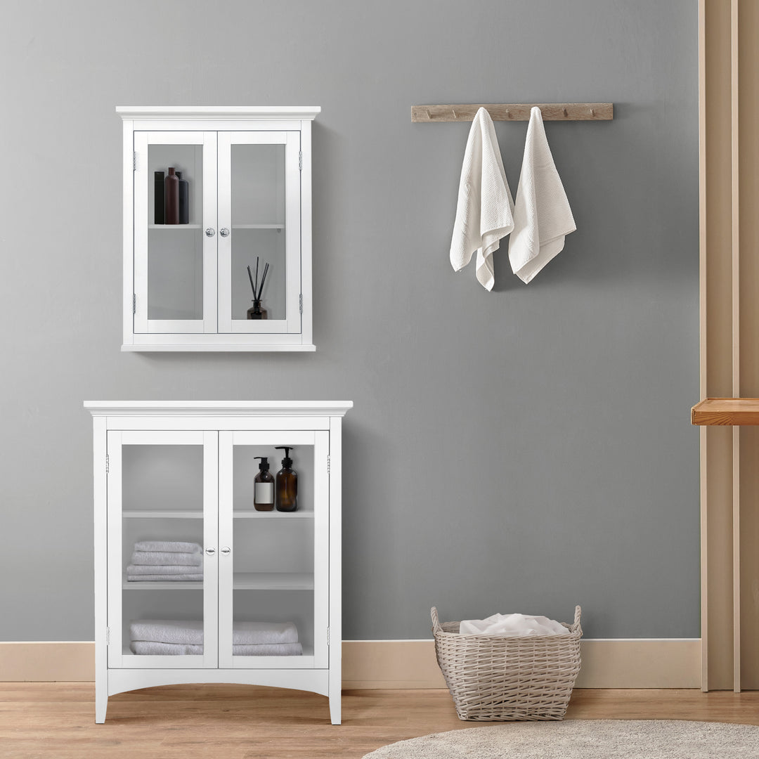 Teamson Home Madison Double Door Floor Storage Cabinet, White , underneath a wall cabinet against a gray wall