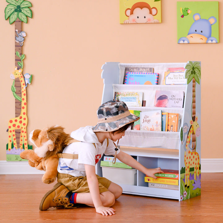 A child selecting a book from the Safari Wooden Display Bookshelf with Storage Cubbies, Multicolor.ntasy Fie